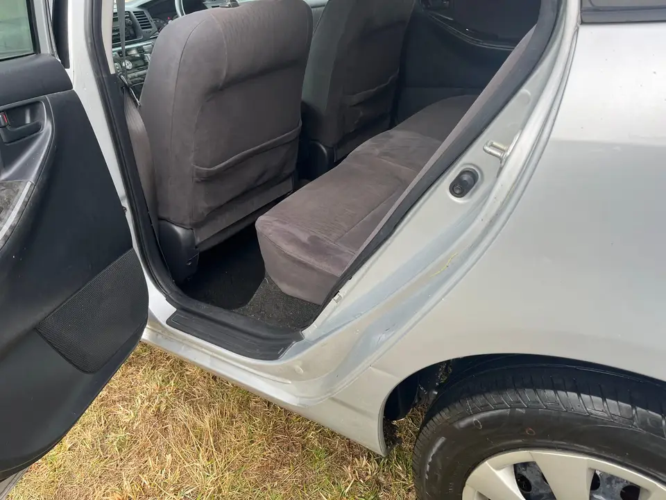 Front passenger door open, showing the seat and sill