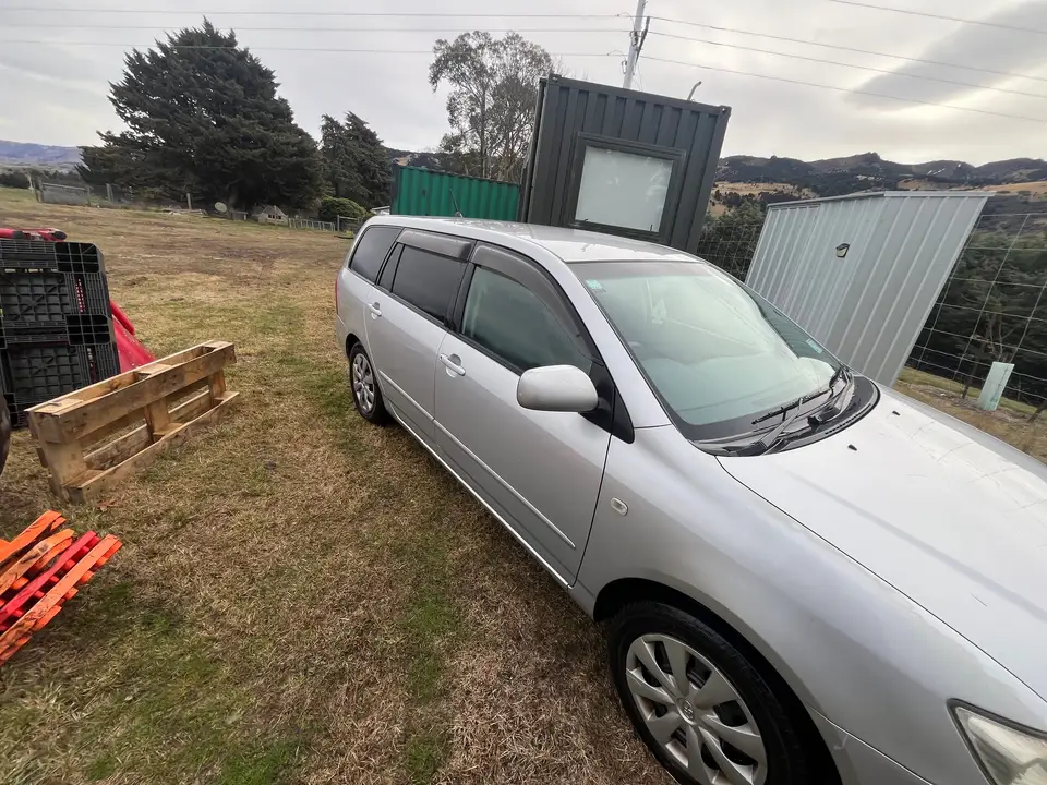 The wagon parked side-on, seen from a distance