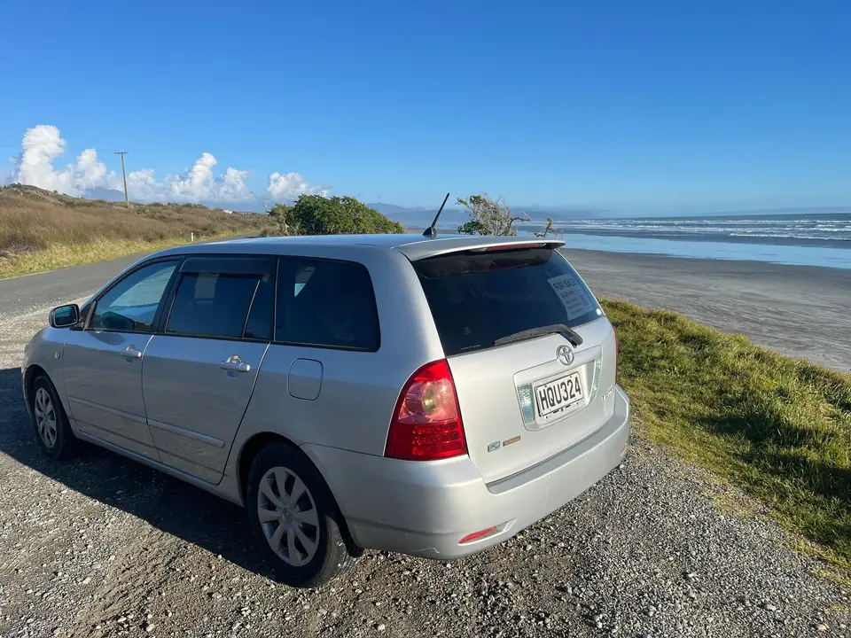 Parked on a grassy headland above the beach