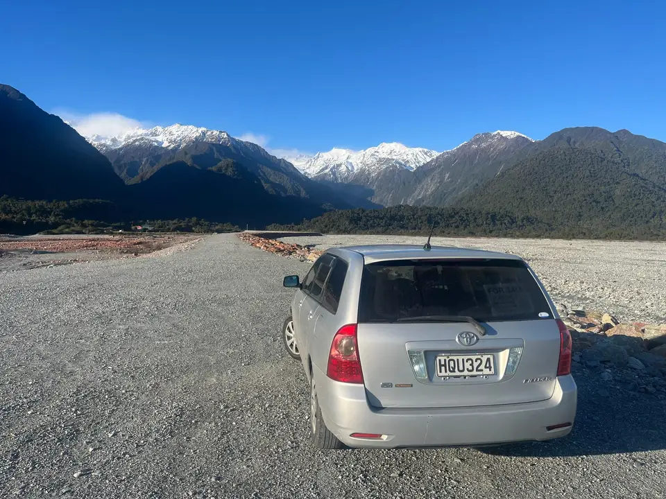 Seen from behind on gravel below snowy mountains