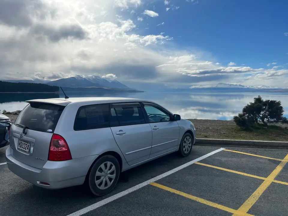 Parked at a lakeside car park with mountains across the water