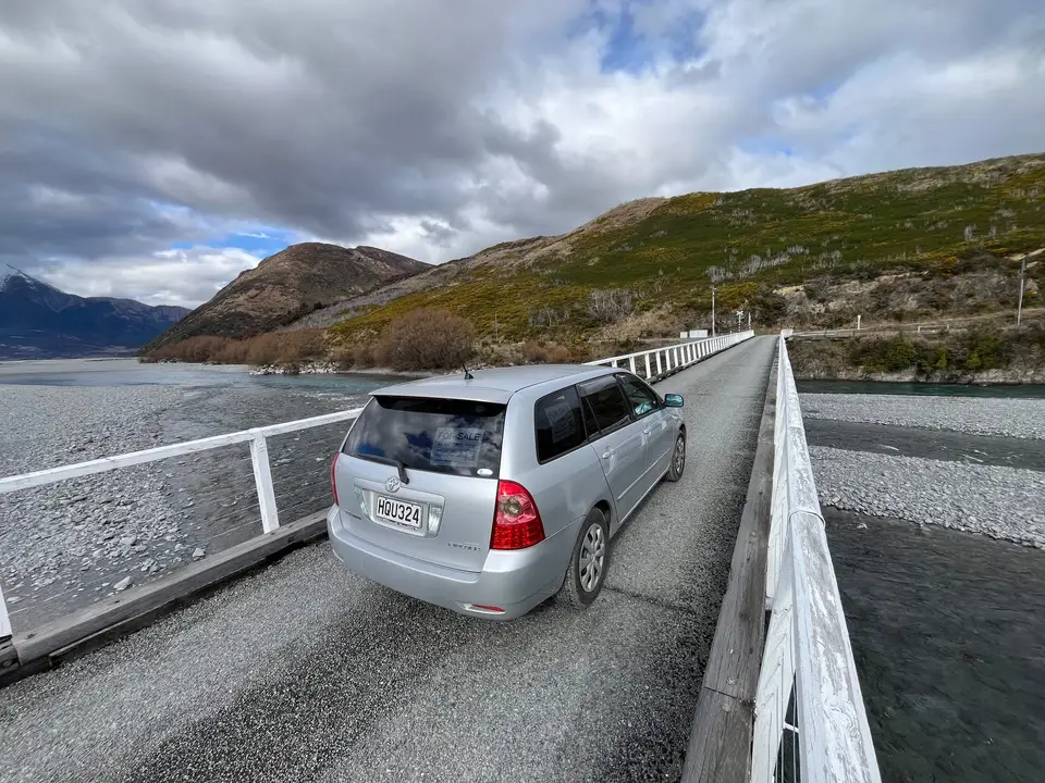 On a one-lane bridge crossing a wide river