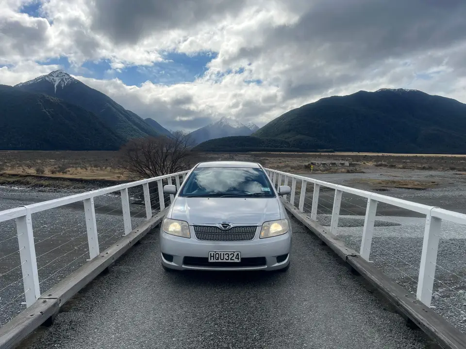 On a one-lane bridge with the mountains ahead