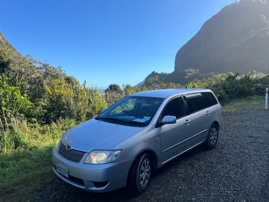 Parked beneath a limestone bluff under a clear sky