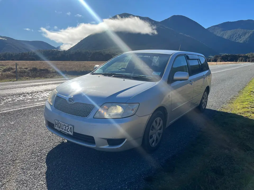 Parked on a wet road below the mountains