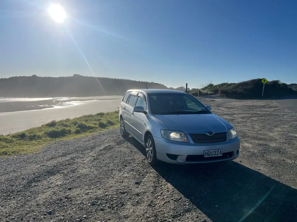 Parked on gravel above a wide beach