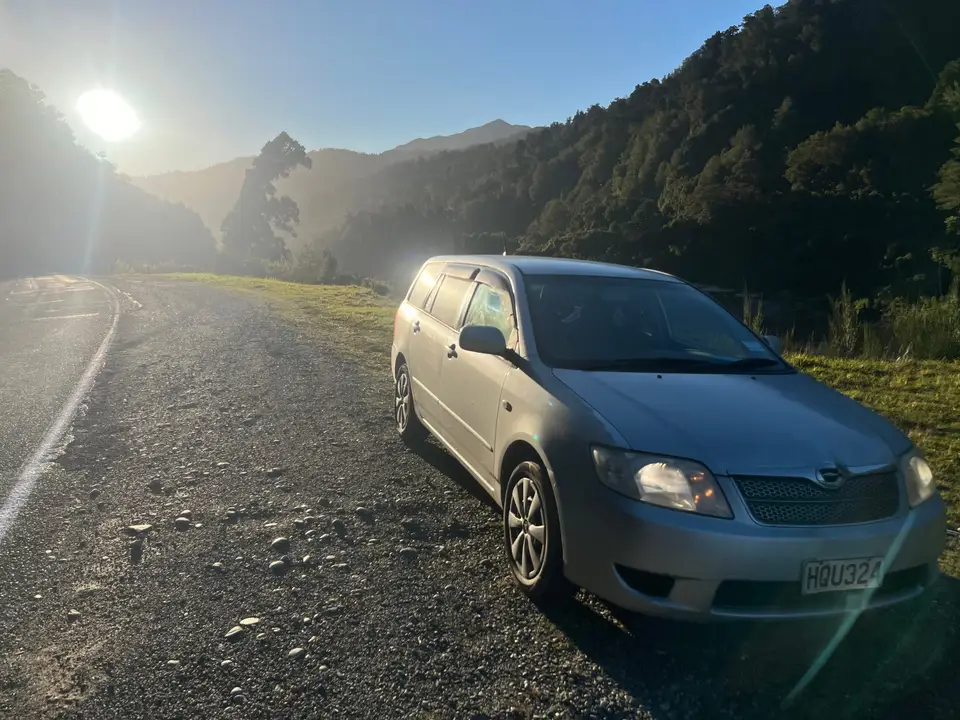 On a misty road with the sun breaking through