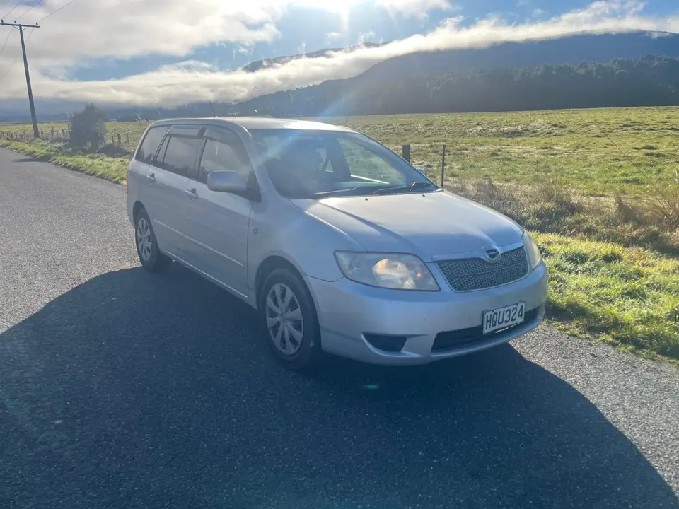 Parked on a roadside with cloud over the ranges